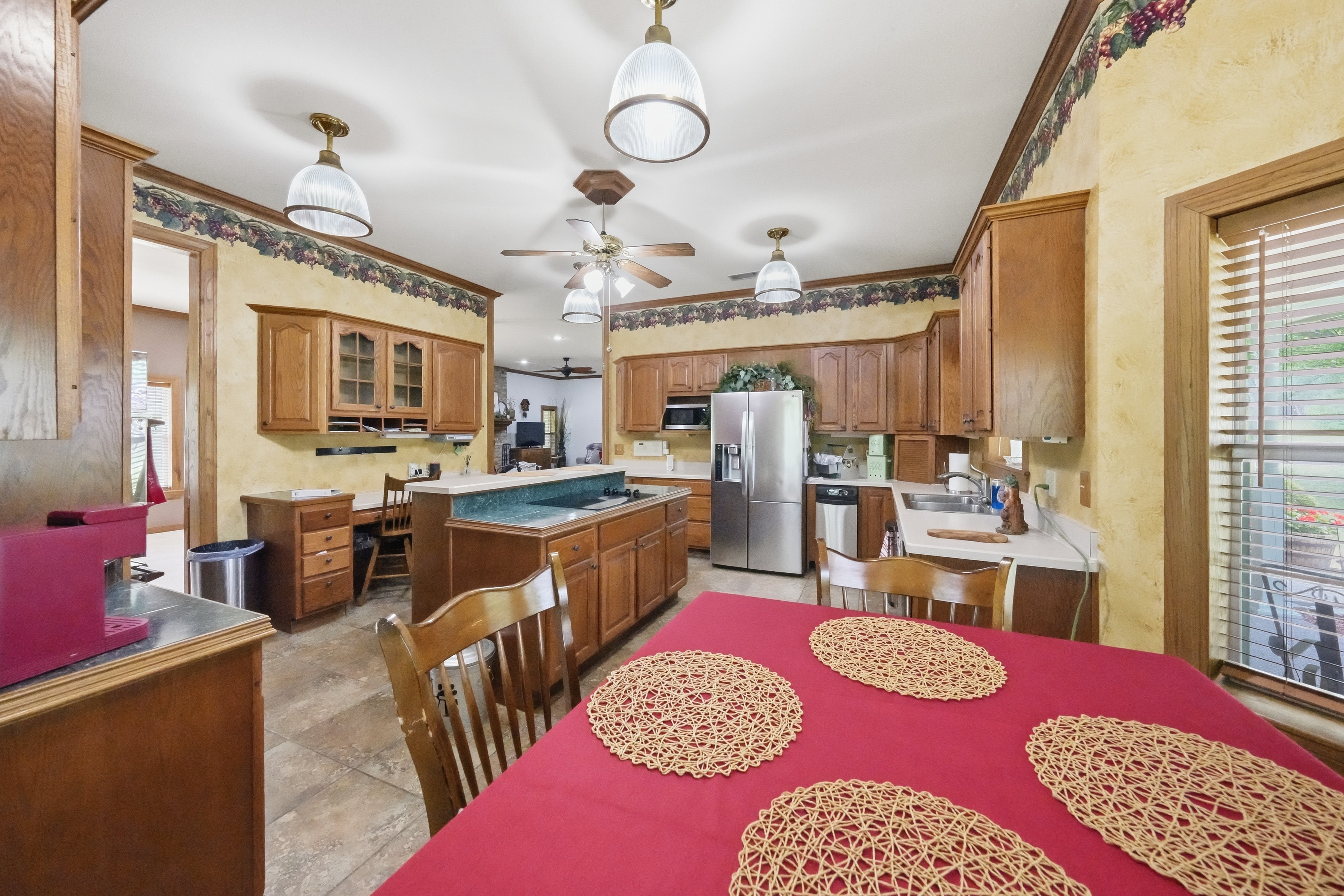 Breakfast nook rotunda with five corner windows and built-in seating box overlooking the front and side yards.