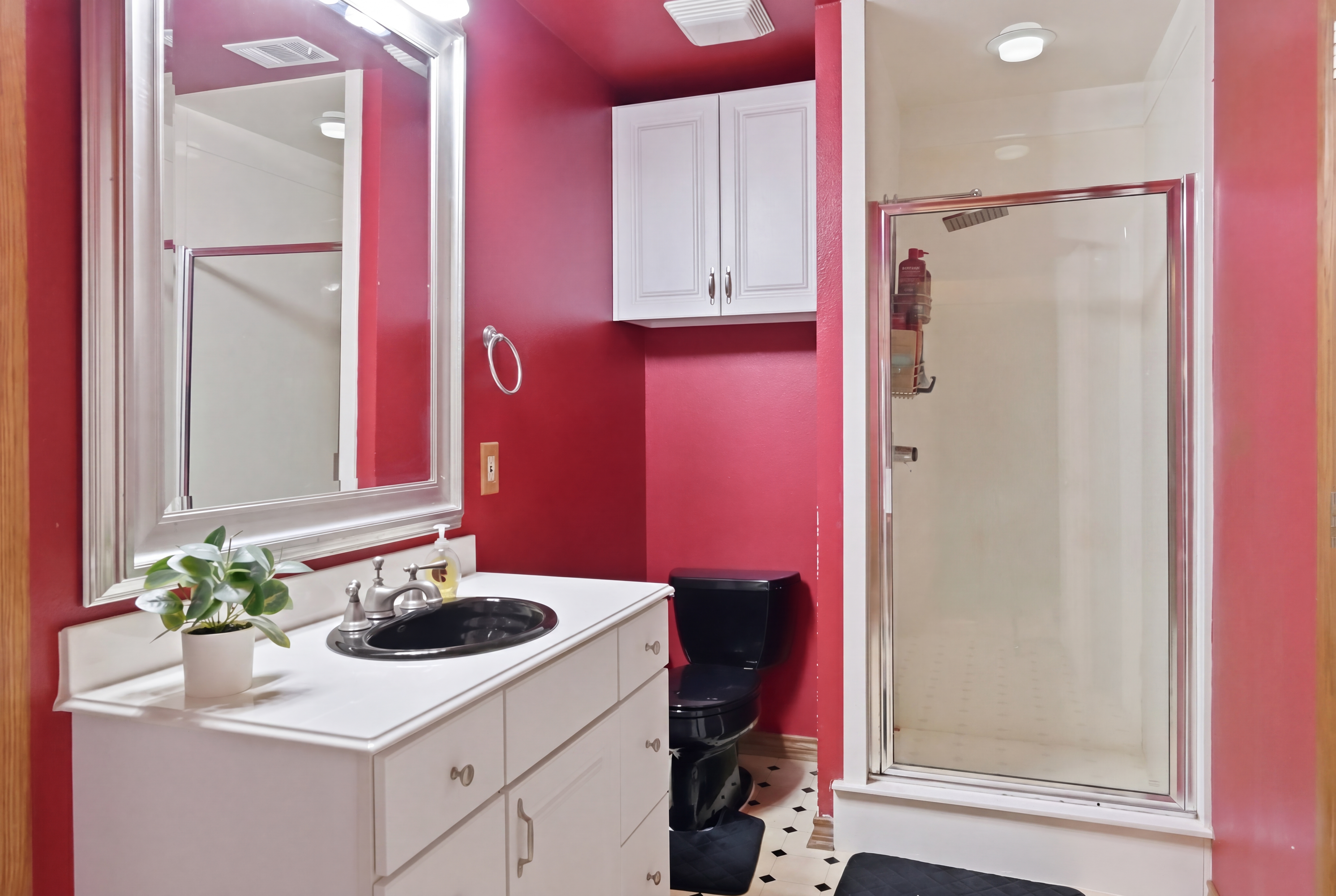 Jack-and-Jill bathroom with cultured marble vanity, double sinks, and tile-surround shower-tub combination.
