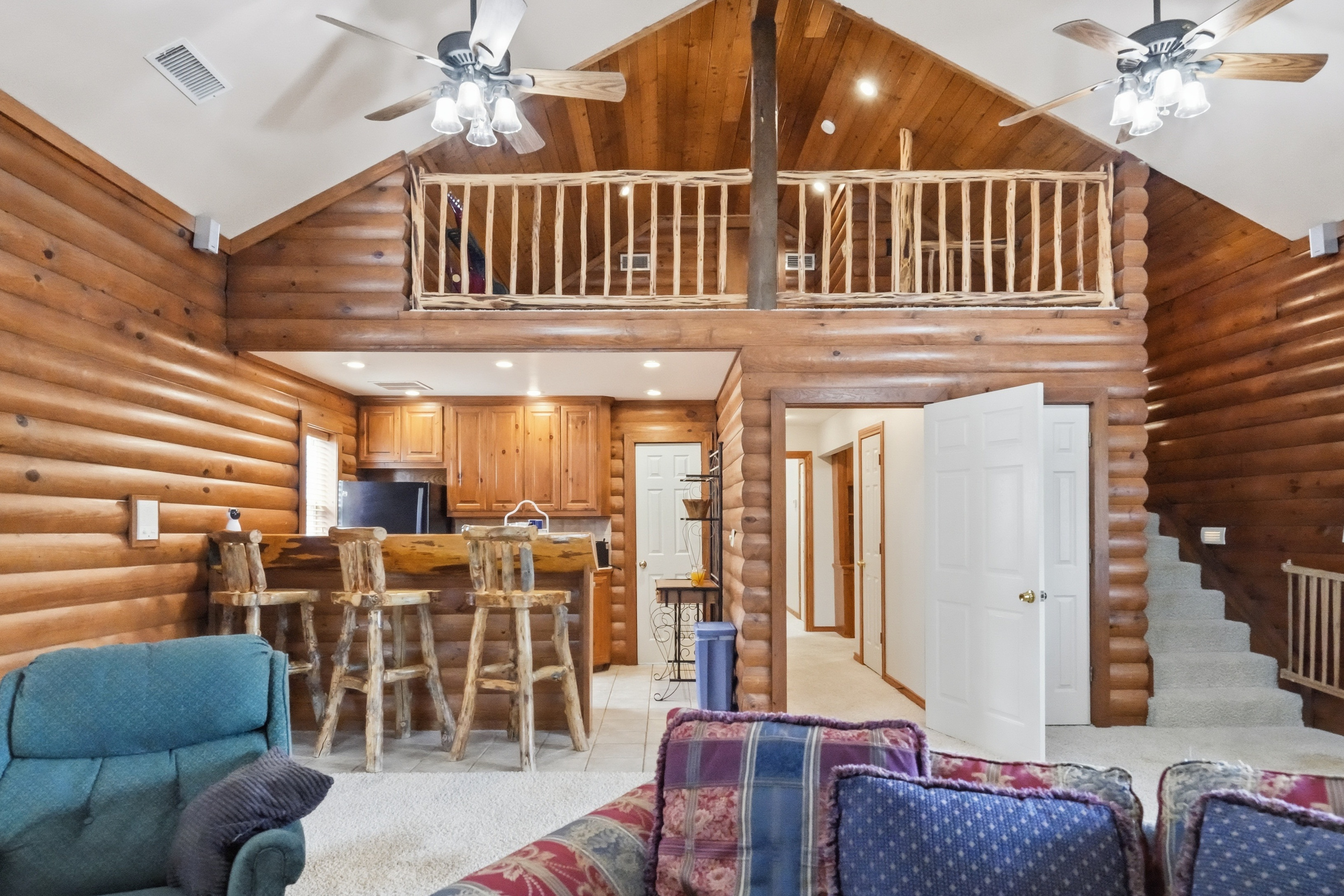 Arts and crafts workshop with bay windows, sewing stations, and built-in storage shelving.